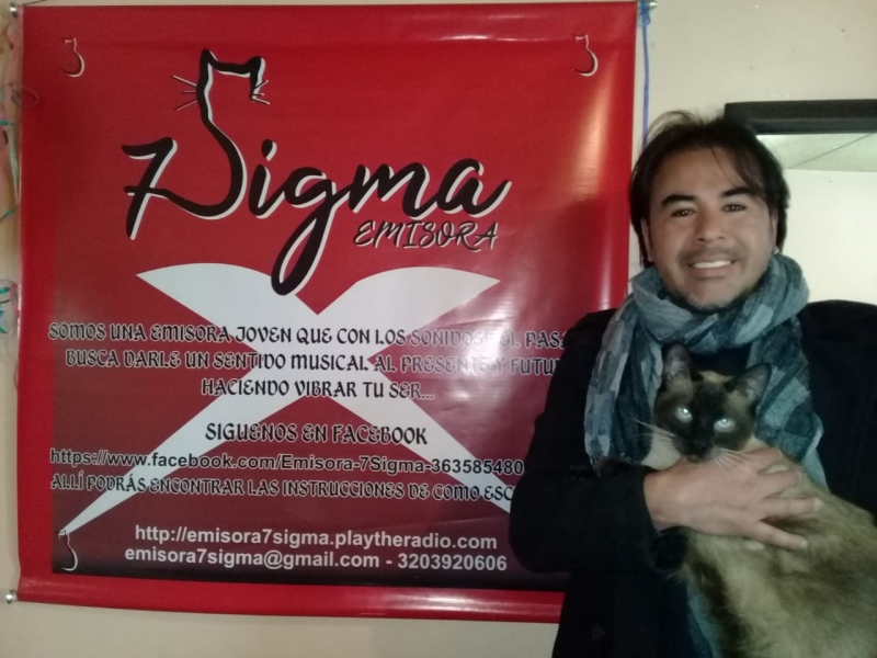 Personajes y Colectivos de Tunjuelito en 2018: Emisora 7Sigma Andres con gato y pendon de 7sigma
